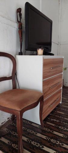 a chair and a tv on top of a dresser at MANGROVE BEACH in Sanyang