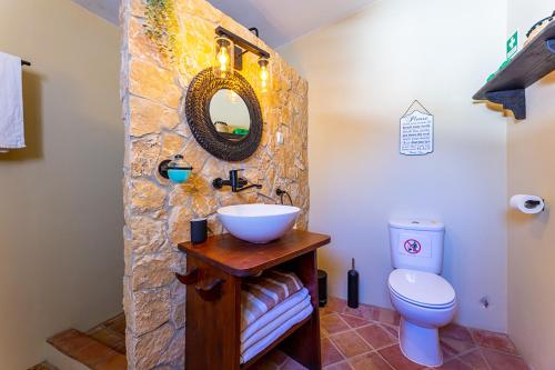a bathroom with a sink and a toilet at Charming country house in Santa Catarina da Fonte do Bispo