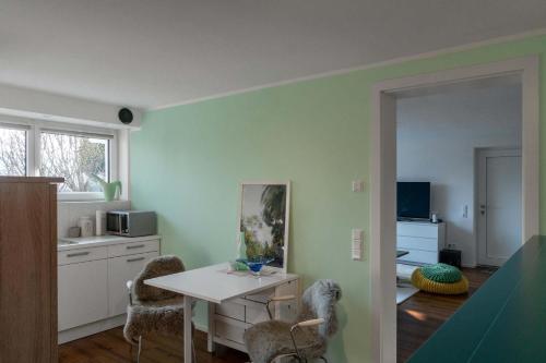a kitchen with a table and chairs in a room at Sunshine River Flat in Hohentengen