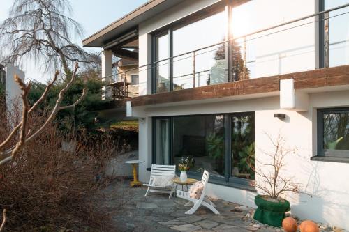 a house with large windows and a patio at Sunshine River Flat in Hohentengen