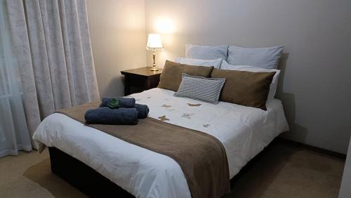 a bedroom with a large white bed with pillows at 741 Tetra Self Catering Accommodation in Pretoria