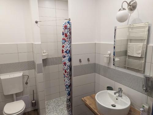 a bathroom with a toilet and a sink at Várfal apartman in Kőszeg