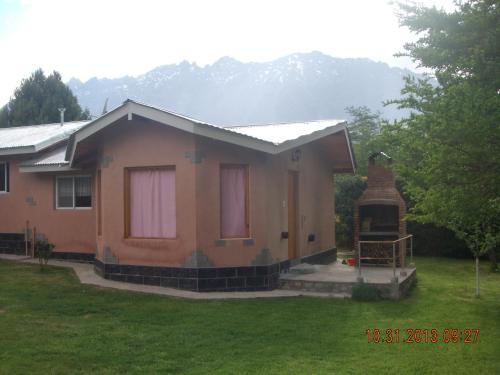 a small house with a gazebo in a yard at Cabañas La Perla in Golondrinas