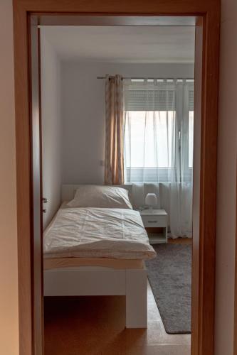 a bedroom with a bed and a window at Ferienwohnung in Kassel