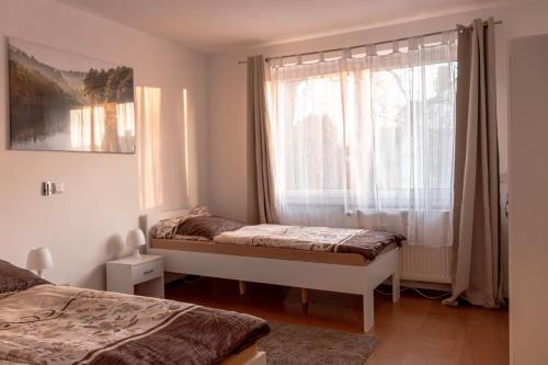 a bedroom with two beds and a window at Ferienwohnung in Kassel