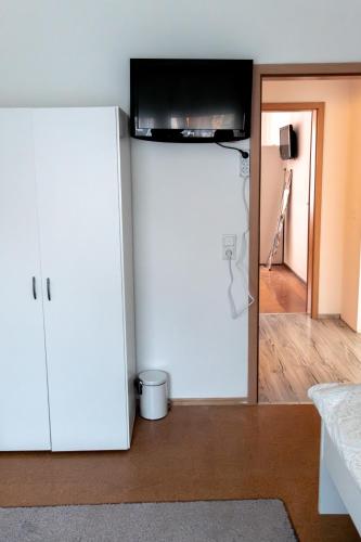 a white refrigerator with a television on top of it at Ferienwohnung in Kassel