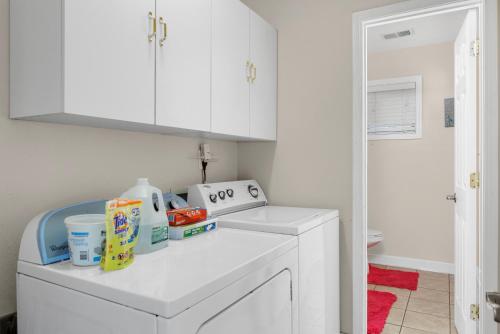 a kitchen with white cabinets and a white dishwasher at Elegant Huge Ocean View 4 King, Private Pool, Huge Yard, Enormous Game Garage, BBQ, & Rooftop Deck in Myrtle Beach