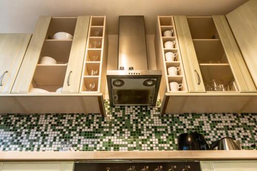 a kitchen with white cabinets and a stove at Ferienwohnung in Kassel