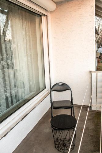 a chair sitting on a porch next to a window at Ferienwohnung in Kassel