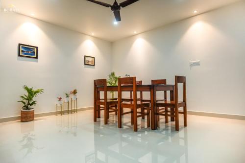a dining room with a table and chairs at Borail Homes in Silchar