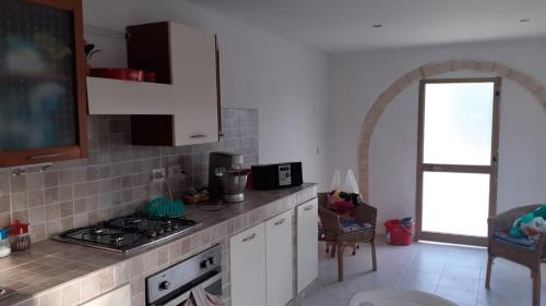 a kitchen with a stove and a counter top at Casa il capricorno in Siracusa