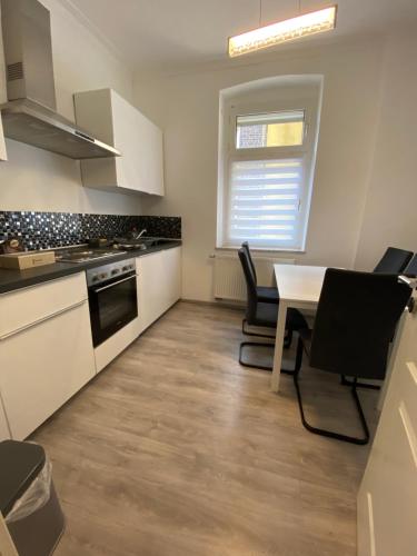 a kitchen with a table and a stove top oven at House-In Apartments - Free Parking - WiFi - Kitchen in Essen