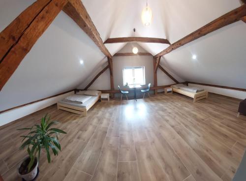 an attic room with a bed and a table at Agroturystyka noclegi podlesie in Gorlice