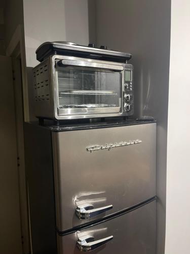 a microwave sitting on top of a refrigerator at Tiny Home Bliss in Harcourt