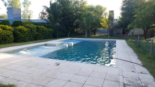 a swimming pool in a yard next to a house at Camino Marquez in Santiago del Estero