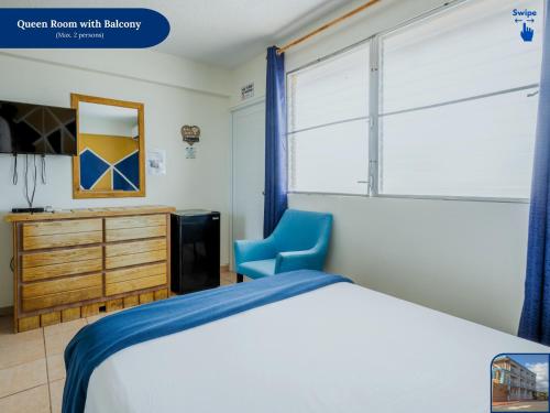 a bedroom with a bed and a blue chair at West Coast Inn's in Boqueron