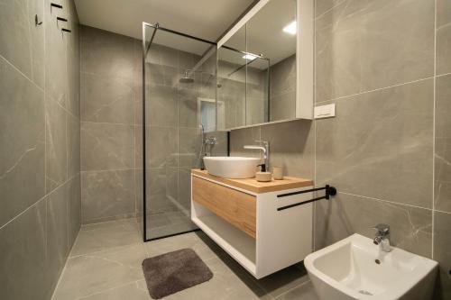 a bathroom with a sink and a shower at AMBER in Rabac