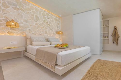 a bedroom with a bed with a bowl of fruit on it at Milos Villas Complex in Pefki Rhodes