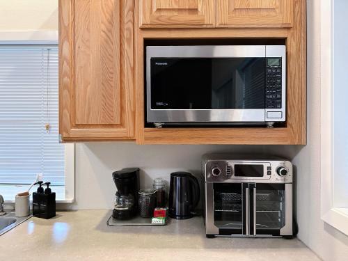 a kitchen with a microwave and a coffee maker at The Secret Garden in Portland