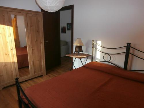 a bedroom with a bed with an orange blanket at B&B La Casa Bianca in Fossacesia