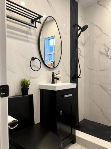 a bathroom with a sink and a mirror at Nice and Cozy guest house in Miami