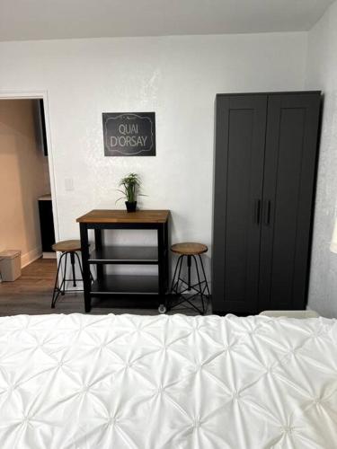a bedroom with a bed and a table with stools at Nice and Cozy guest house in Miami