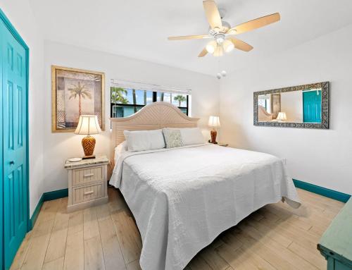 a bedroom with a bed and a ceiling fan at Uptown Cottage - Walk to the Beach and Restaurants in Cocoa Beach