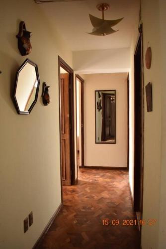 a hallway with a mirror and a ceiling at Family House in La Paz