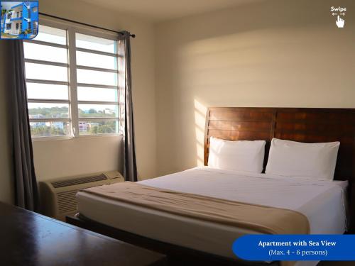 a bedroom with a bed with a large window at West Coast Inn's in Boqueron