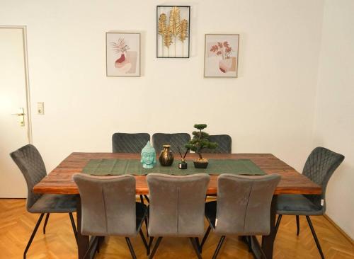 a dining room table with six chairs and a table and ahibition at Beautiful Apartments Near Hauptbahnhof in Vienna