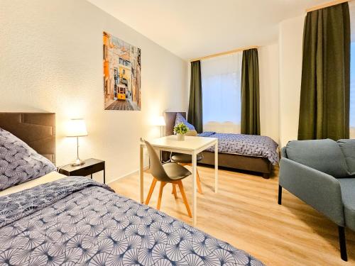 a hotel room with a bed and a table at Centerline Apartments Solingen in Solingen