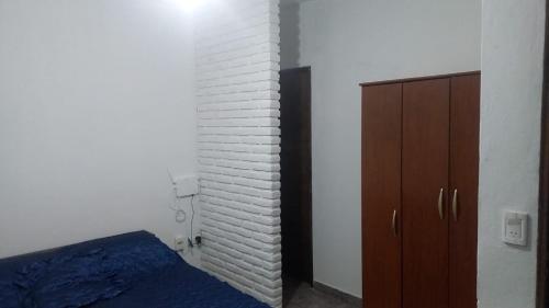 a bedroom with a bed and a brick wall at Casa Familiar in Mar del Plata