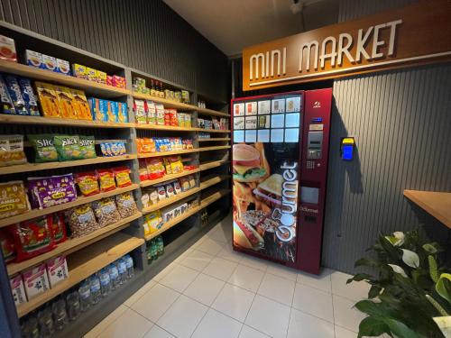 a grocery store aisle with a soda machine in a store at Link Araranguá in Araranguá