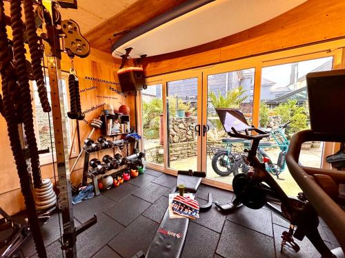 a room with a room with a gym with a bike and a room with at Brightham House in Salcombe