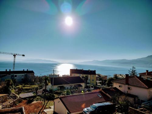 a view of a city with the sun in the sky at Viridis in Rijeka