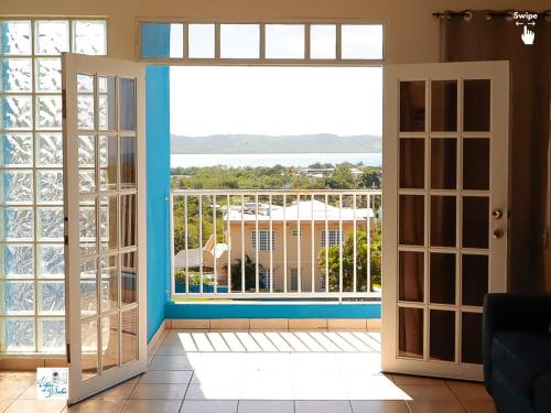 an open door to a balcony with a view at West Coast Inn's in Boqueron