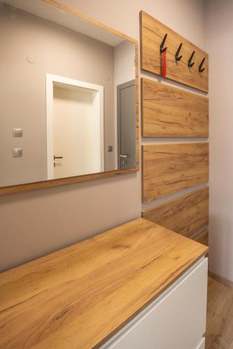 a dressing room with a mirror and a wooden counter at Open Sea Panorama Residence in Obzor
