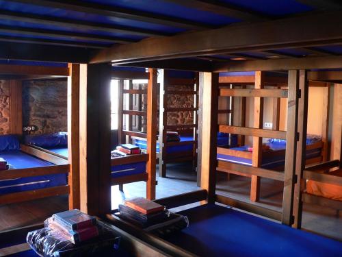 a room with several bunk beds in it at Albergue la Medina de Camponaraya in Camponaraya