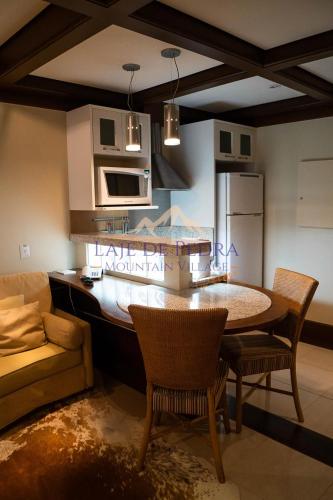 a kitchen with a table and chairs in a room at Laje de Pedra Mountain VillagePrime in Canela
