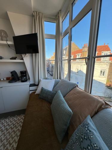 une chambre avec un lit et une grande fenêtre dans l'établissement Maison Belle Rade : L’écoutille, à Dunkerque