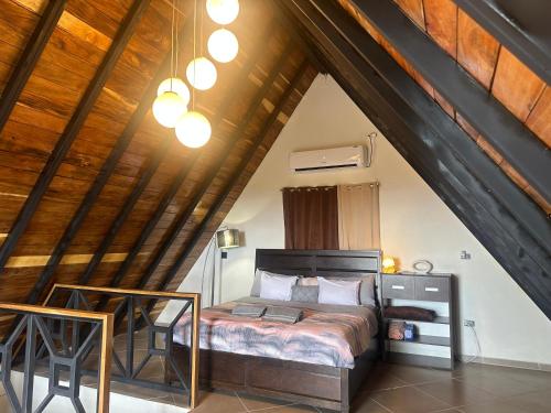 a bedroom with a bed in an attic at Piece Of Heaven Cabins in Palmira