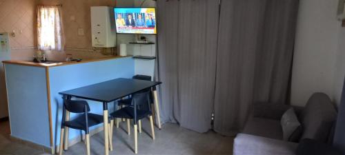 a small kitchen with a black table and chairs at Moreno 40 in Colón