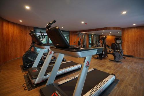 a gym with several treadmills and elliptical machines at Seamira House Huahin in Hua Hin