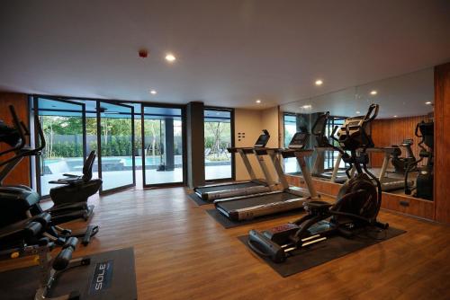 a gym with several treadmills and elliptical machines at Seamira House Huahin in Hua Hin