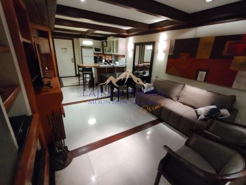 a living room with a couch and a table at Laje de Pedra Mountain VillagePrime in Canela
