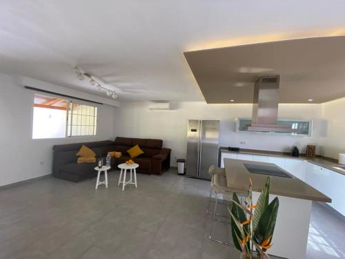 a large living room with a couch and a kitchen at SUNNY CARMELITO DELUXE in Mogán