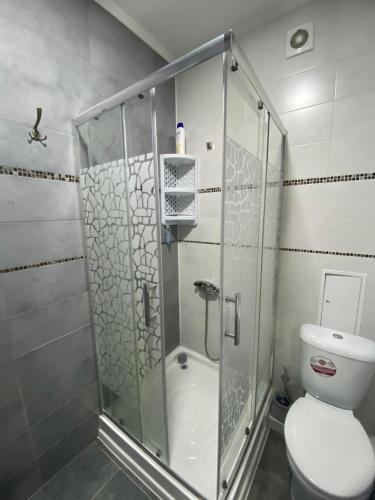 a bathroom with a glass shower with a toilet at Moldova Balți center in Bălţi