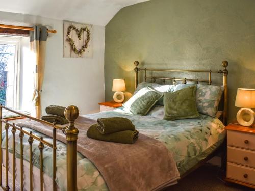 a bedroom with a bed with green walls at Middle Kellet - Uk46180 in Silecroft