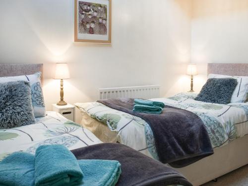 dos camas sentadas una al lado de la otra en un dormitorio en West Kellet, en Silecroft