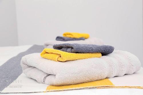 a pile of towels sitting on top of a table at Inviting 3-Bed Apartment in Bromley in Bromley